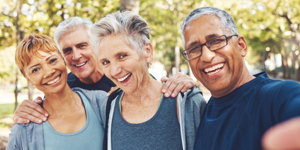 Four senior friends walking outdoors