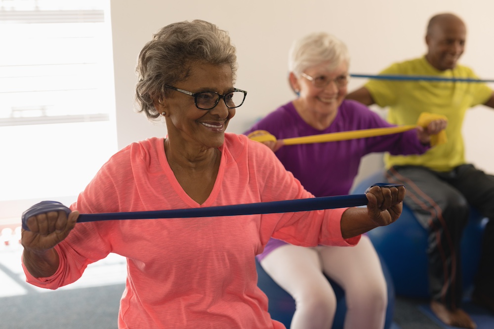 A group of seniors take a fitness class at their Glendale assisted living community