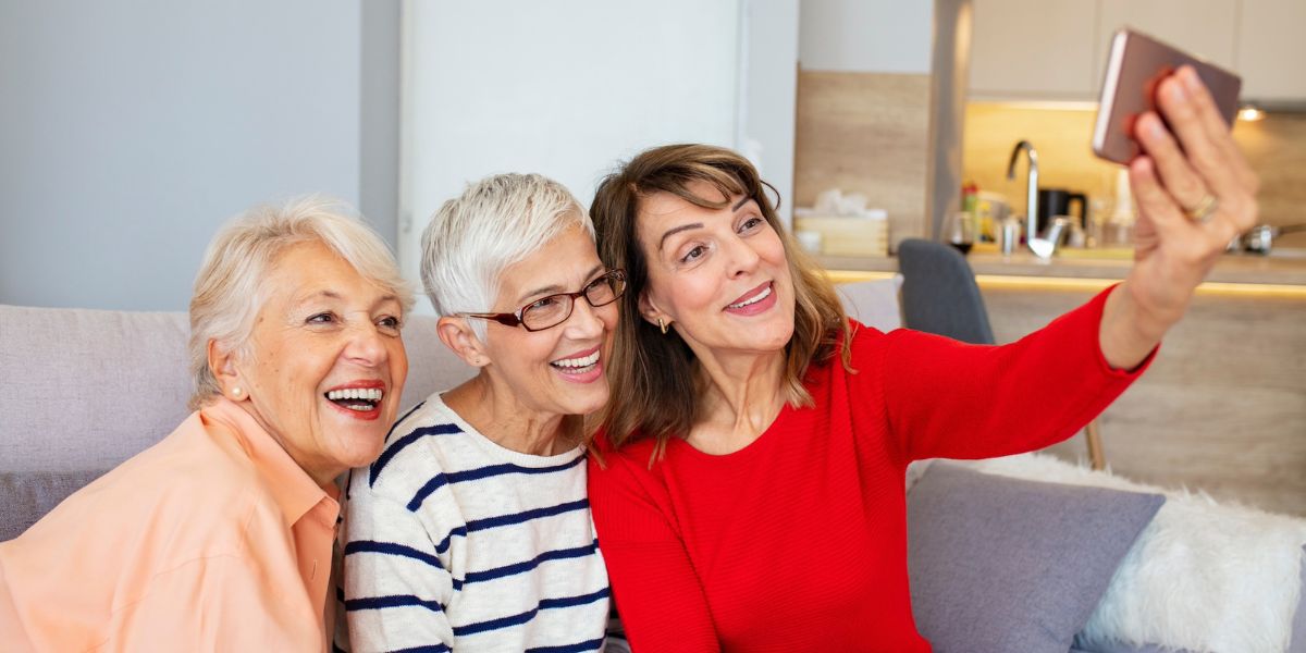 Three older women taking a selfie at one of the best senior living communities in Glendale, CA