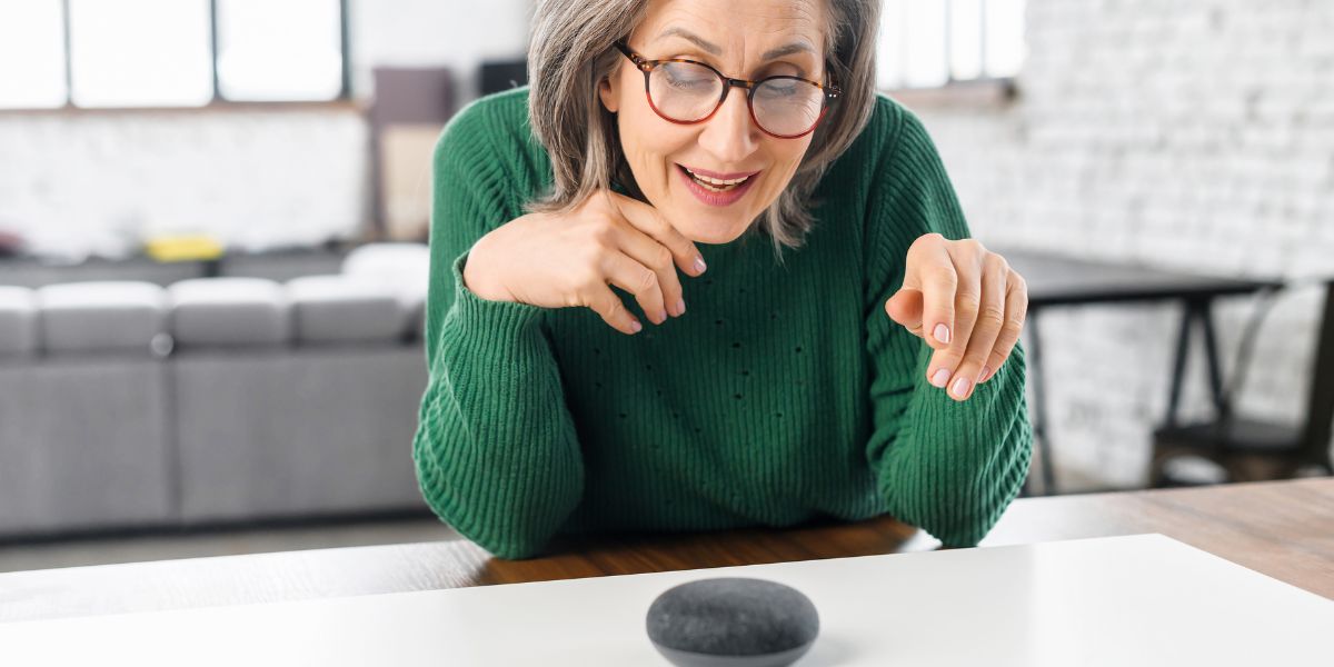 A senior woman giving a voice command to a smart home device
